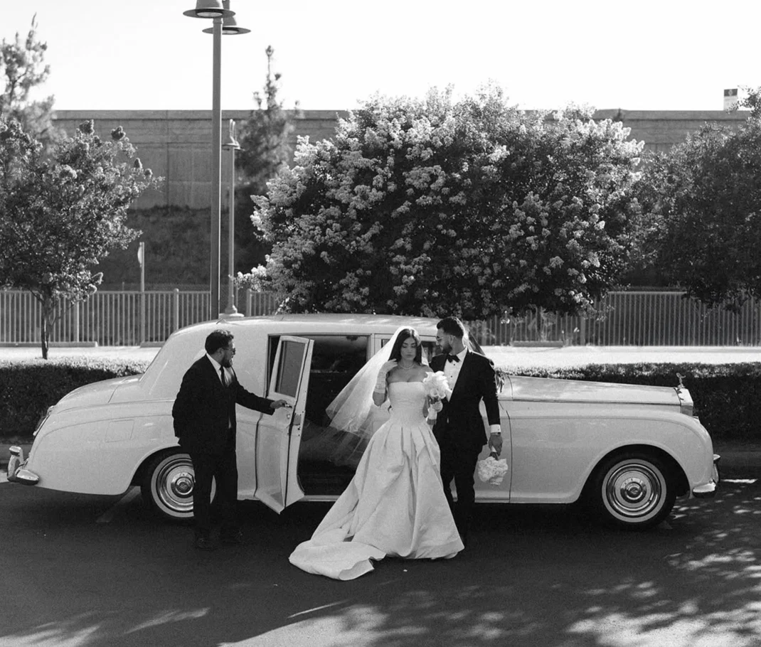 Bride and groom beside a classic Rolls-Royce